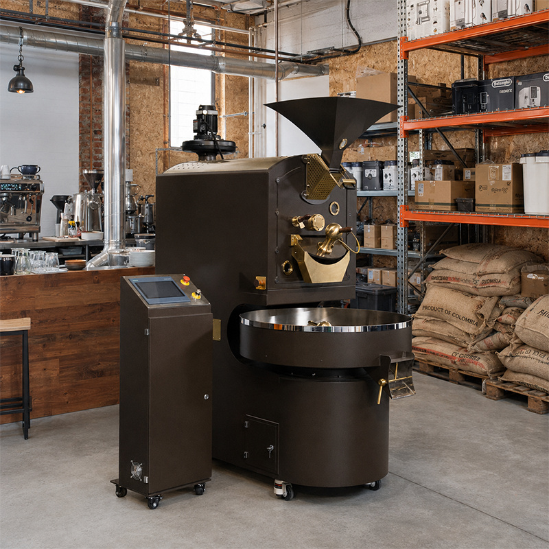 Yoshan drum roaster in a small roastery beside green coffee sacks