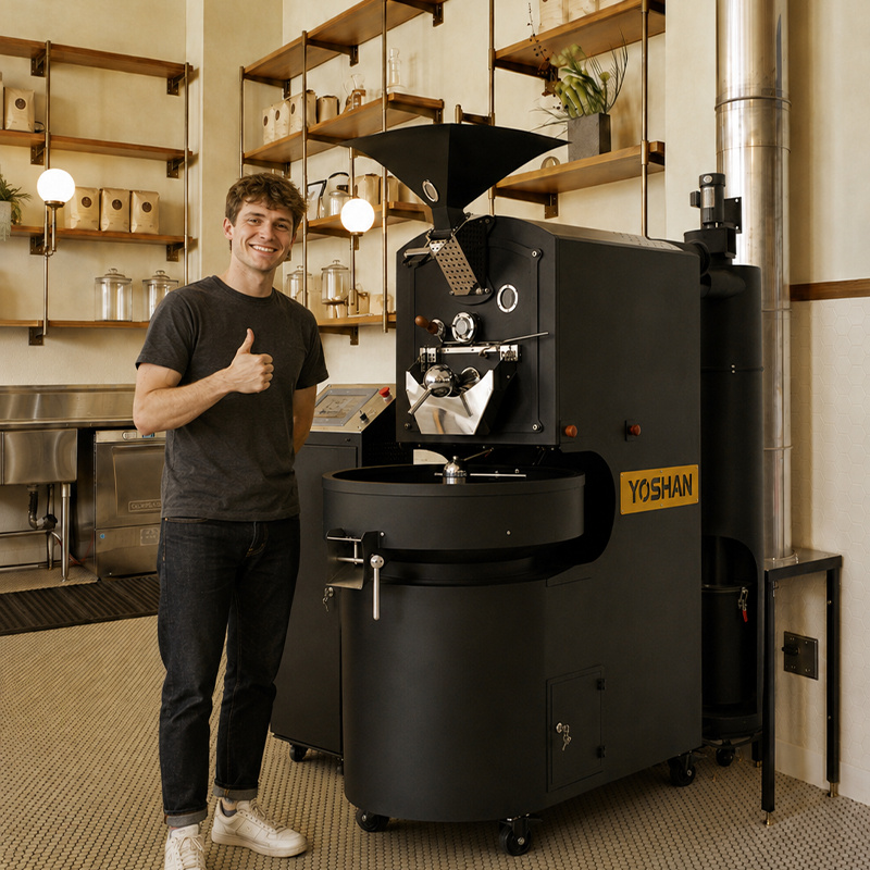 Cafe owner standing beside a Yoshan coffee roaster