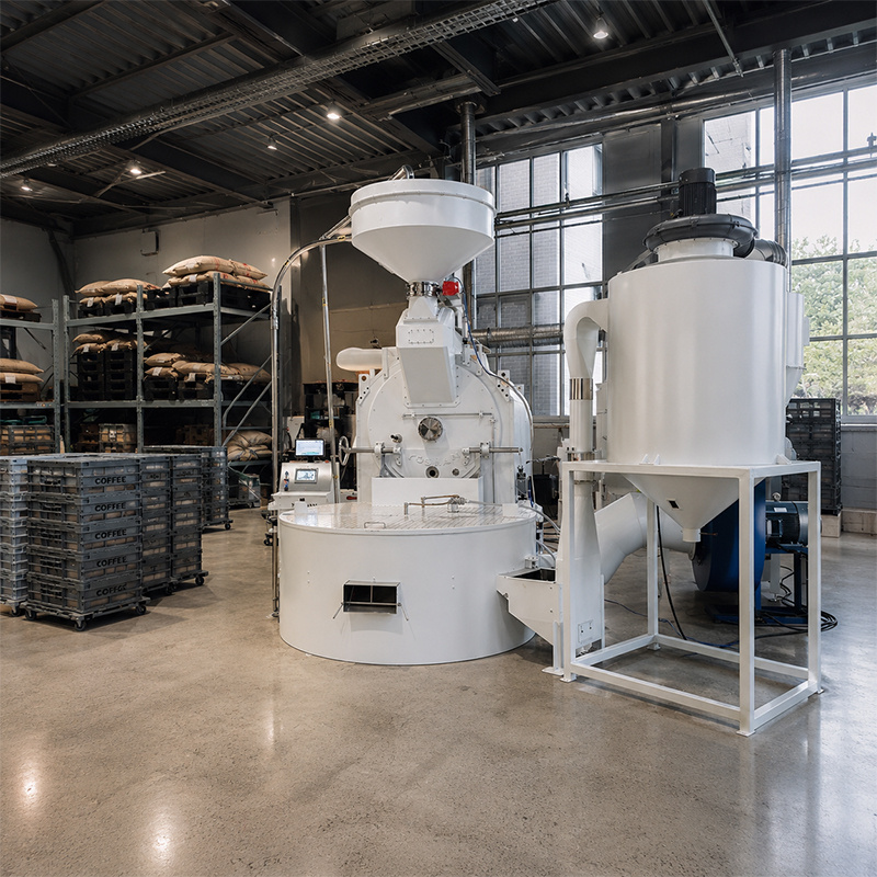 White Yoshan industrial coffee roaster with green bean loader and silo
