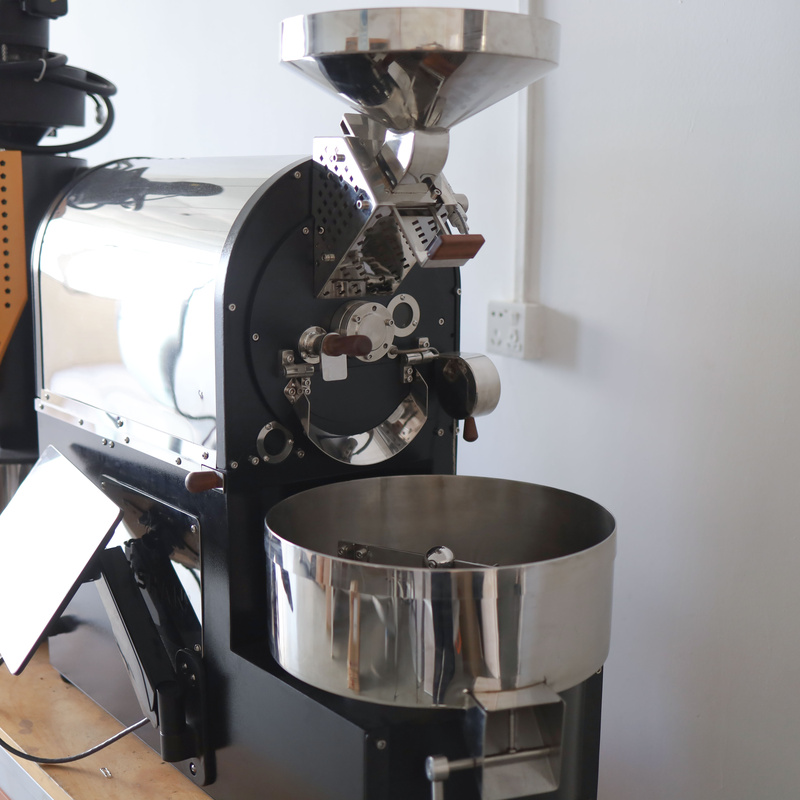Bean hopper and drum front of a Yoshan coffee roaster